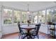 Sunlit dining area surrounded by windows, providing beautiful views of the outdoors at 8115 Adams Run School Rd, Adams Run, SC 29426