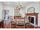 Dining room featuring hardwood floors, wood-burning fireplace and elegant lighting fixture at 8115 Adams Run School Rd, Adams Run, SC 29426