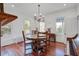 Charming dining area with hardwood floors, farmhouse chandelier and abundant natural light at 8115 Adams Run School Rd, Adams Run, SC 29426