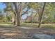 Charming two-story home as seen through a grove of mature trees at 8115 Adams Run School Rd, Adams Run, SC 29426