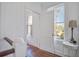 White hallway with natural light, wood floors and staircase that lead to the rest of the home at 8115 Adams Run School Rd, Adams Run, SC 29426