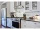 Updated kitchen featuring stainless steel appliances, white cabinets, and sleek countertops at 8115 Adams Run School Rd, Adams Run, SC 29426