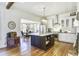 Open kitchen with center island, stainless appliances, hardwood floors, and view to dining area at 8115 Adams Run School Rd, Adams Run, SC 29426