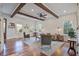 Bright living room featuring hardwood floors, exposed beam ceilings, and comfortable, stylish seating at 8115 Adams Run School Rd, Adams Run, SC 29426