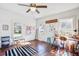 Bright room featuring hardwood floors, white walls, and a ceiling fan with natural light from the windows at 8115 Adams Run School Rd, Adams Run, SC 29426