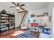 Bright room with hardwood floors and a ceiling fan, featuring a cozy armchair and a charming dollhouse at 8115 Adams Run School Rd, Adams Run, SC 29426