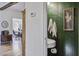 Stylish powder room with green walls and white fixtures and sink adding a pop of color at 8115 Adams Run School Rd, Adams Run, SC 29426