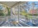 Relaxing screened porch with rocking chair, a side table, and scenic views at 8115 Adams Run School Rd, Adams Run, SC 29426