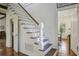 Traditional staircase featuring white wood risers and a wooden handrail that provides a timeless look at 8115 Adams Run School Rd, Adams Run, SC 29426