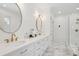 Bright bathroom with dual sinks, elegant mirrors, and a glass-enclosed shower at 873 Tupelo Bay Dr, Mount Pleasant, SC 29464