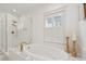 Serene bathroom features a soaking tub, glass shower, and natural light from the window at 873 Tupelo Bay Dr, Mount Pleasant, SC 29464