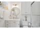 Elegant bathroom boasts white cabinets, a round mirror, and modern gold-tone fixtures at 873 Tupelo Bay Dr, Mount Pleasant, SC 29464