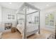 Cozy bedroom featuring a four-poster bed, hardwood floors, and natural light from windows at 873 Tupelo Bay Dr, Mount Pleasant, SC 29464