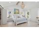 Bright and airy bedroom features a vaulted ceiling, chandelier, and white four-poster bed at 873 Tupelo Bay Dr, Mount Pleasant, SC 29464