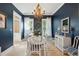 Elegant dining room showcasing a modern chandelier, navy walls, and a glass table with white chairs at 873 Tupelo Bay Dr, Mount Pleasant, SC 29464