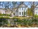 Charming two-story home featuring a landscaped yard and a classic white picket fence at 873 Tupelo Bay Dr, Mount Pleasant, SC 29464