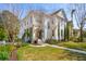 Beautiful two-story home featuring a lush green lawn, mature trees, and welcoming front porch at 873 Tupelo Bay Dr, Mount Pleasant, SC 29464