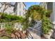 Exterior garden with an arched ivy gate leading to an outdoor dining area at 873 Tupelo Bay Dr, Mount Pleasant, SC 29464