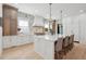 Modern gourmet kitchen featuring a center island with seating, a stylish backsplash and stainless appliances at 873 Tupelo Bay Dr, Mount Pleasant, SC 29464