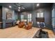 Cozy living room features a fireplace, hardwood floors, and natural light from shuttered windows at 873 Tupelo Bay Dr, Mount Pleasant, SC 29464