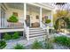 Inviting front porch with columns, a bench swing, and lush landscaping at 873 Tupelo Bay Dr, Mount Pleasant, SC 29464