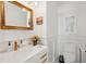Elegant powder room boasts a gold-framed mirror, stylish fixtures, and wainscoting detail at 873 Tupelo Bay Dr, Mount Pleasant, SC 29464