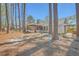 Backyard with lush trees, screened porch, and brick walkway offering a serene outdoor living space at 891 Wynford Ct, Mount Pleasant, SC 29464