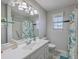 Bathroom features a white vanity with ample lighting, a shower, and an adjacent toilet at 891 Wynford Ct, Mount Pleasant, SC 29464