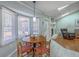 Bright breakfast nook features a wooden table set near large windows and a view of the living area at 891 Wynford Ct, Mount Pleasant, SC 29464