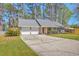 Charming single-story home with a well-kept lawn, mature trees, and convenient two-car garage at 891 Wynford Ct, Mount Pleasant, SC 29464