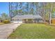 Charming single-story home featuring a well-manicured lawn, mature trees, and a two-car garage at 891 Wynford Ct, Mount Pleasant, SC 29464