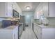 Galley kitchen boasts stainless steel appliances, granite countertops, and white cabinetry at 891 Wynford Ct, Mount Pleasant, SC 29464