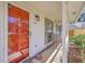 Inviting front porch featuring a bright red door, cozy seating, and charming exterior details at 891 Wynford Ct, Mount Pleasant, SC 29464