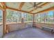 Relaxing screened porch featuring a ceiling fan, outdoor seating, and views of the lush surrounding landscape at 891 Wynford Ct, Mount Pleasant, SC 29464