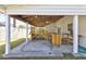 A covered back patio with an elevated deck and a serving bar offers great outdoor living space at 9861 Levenshall Dr, Ladson, SC 29456