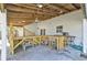 Spacious covered patio with custom bar, exposed rafters, and ceiling fan at 9861 Levenshall Dr, Ladson, SC 29456