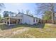 Expansive backyard with covered patio, perfect for outdoor activities at 9861 Levenshall Dr, Ladson, SC 29456