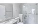 Modern bathroom with a glass-enclosed shower, granite counter, and white marble tile at 9861 Levenshall Dr, Ladson, SC 29456