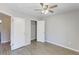 Light-filled bedroom with wood floors, ceiling fan, closet and a view to bathroom at 9861 Levenshall Dr, Ladson, SC 29456