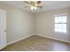 Inviting bedroom featuring wood floors, a ceiling fan, and a window for natural light at 9861 Levenshall Dr, Ladson, SC 29456