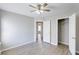 Spacious bedroom featuring wood floors, a ceiling fan, closet, and access to hallway at 9861 Levenshall Dr, Ladson, SC 29456
