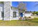 Charming home featuring a blue door, white siding, and a cozy porch with a rocking chair at 9861 Levenshall Dr, Ladson, SC 29456