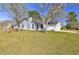 Beautifully landscaped front yard and classic painted brick home with attached garage at 9861 Levenshall Dr, Ladson, SC 29456