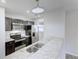 Modern kitchen with stainless steel appliances, granite countertops, and modern lighting at 9861 Levenshall Dr, Ladson, SC 29456