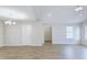 Open-concept living room featuring hardwood floors, neutral paint, and modern chandelier at 9861 Levenshall Dr, Ladson, SC 29456