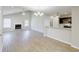 Spacious living room with a fireplace, ceiling fan, and adjoins the kitchen with a granite countertop bar at 9861 Levenshall Dr, Ladson, SC 29456