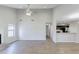 Open-concept living room with hardwood floors, lots of natural light, and view to the kitchen at 9861 Levenshall Dr, Ladson, SC 29456