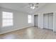 Bright main bedroom with high ceiling, wood floors, closet, and two windows with blinds at 9861 Levenshall Dr, Ladson, SC 29456
