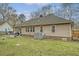 Back exterior features a spacious yard, patio, mature trees, and a well-maintained lawn at 101 Plantation Dr, Summerville, SC 29485