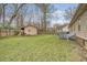 Large backyard with a storage shed, green lawn, and trees providing shade at 101 Plantation Dr, Summerville, SC 29485